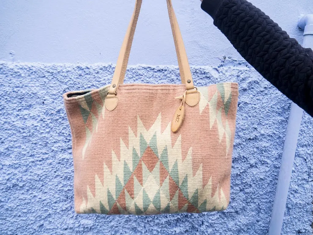 a hand holding an MZ bag
