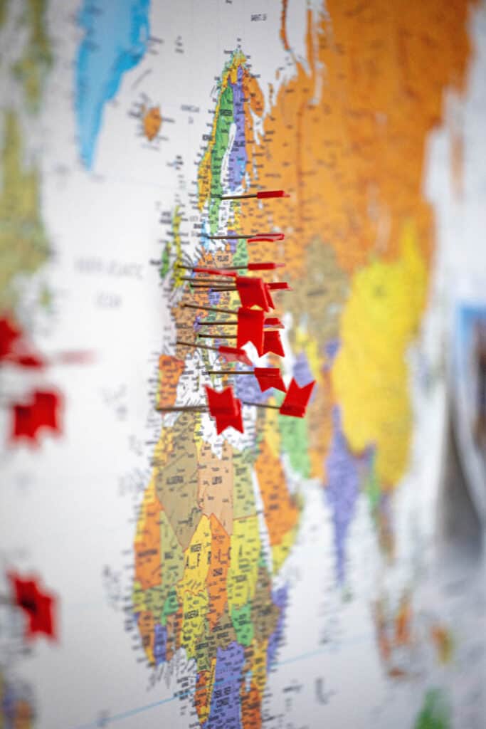 red push pins on a world map