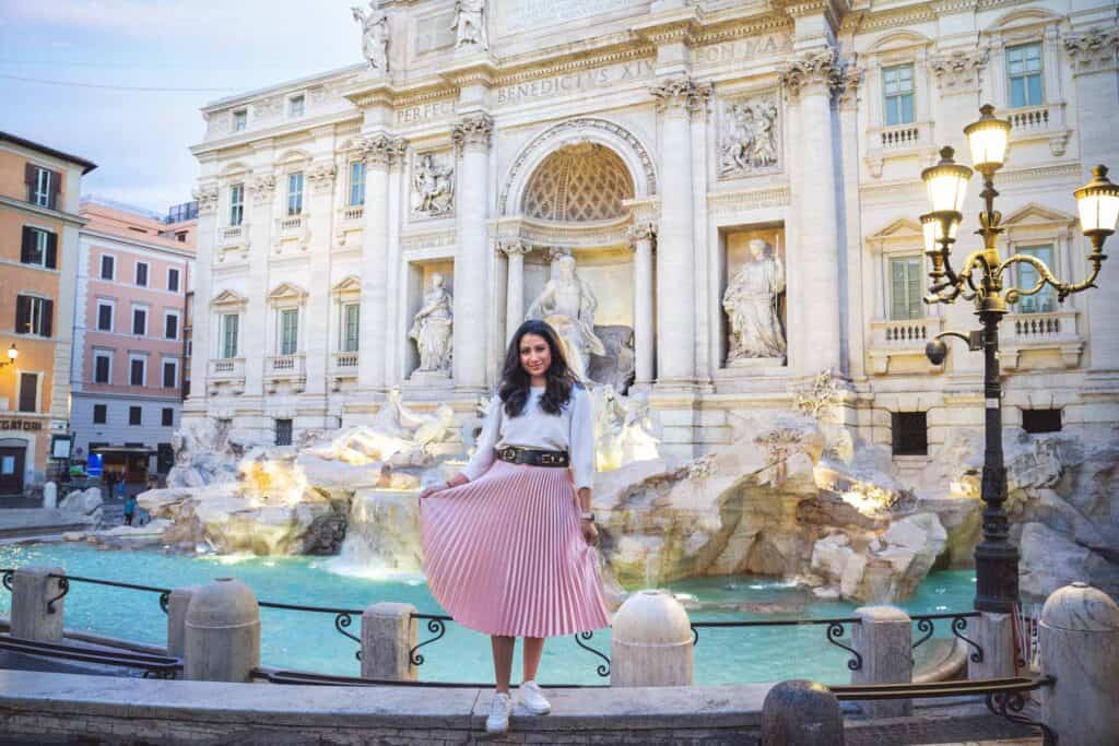 girl standing in front of the Trevi Fountain in Rome, Italy