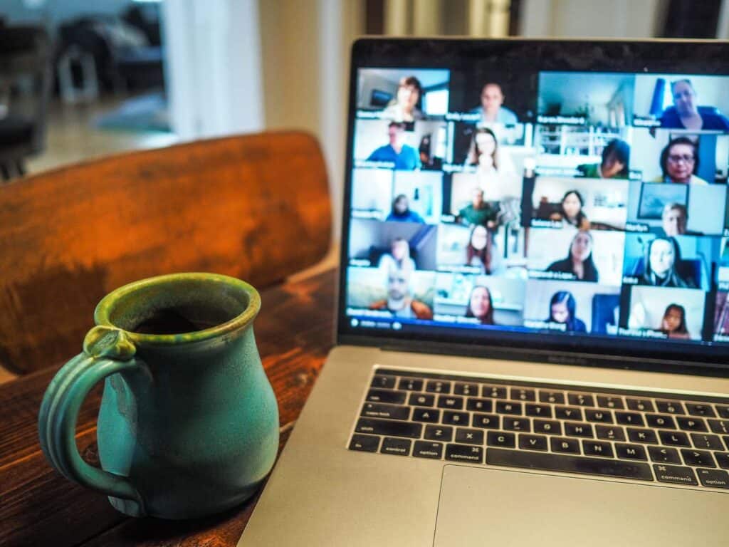 work call on a laptop with a coffee mug