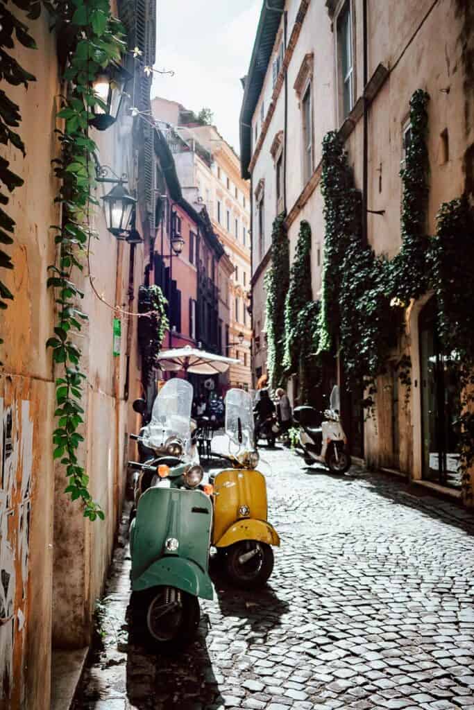 a street in Rome with two Vespas