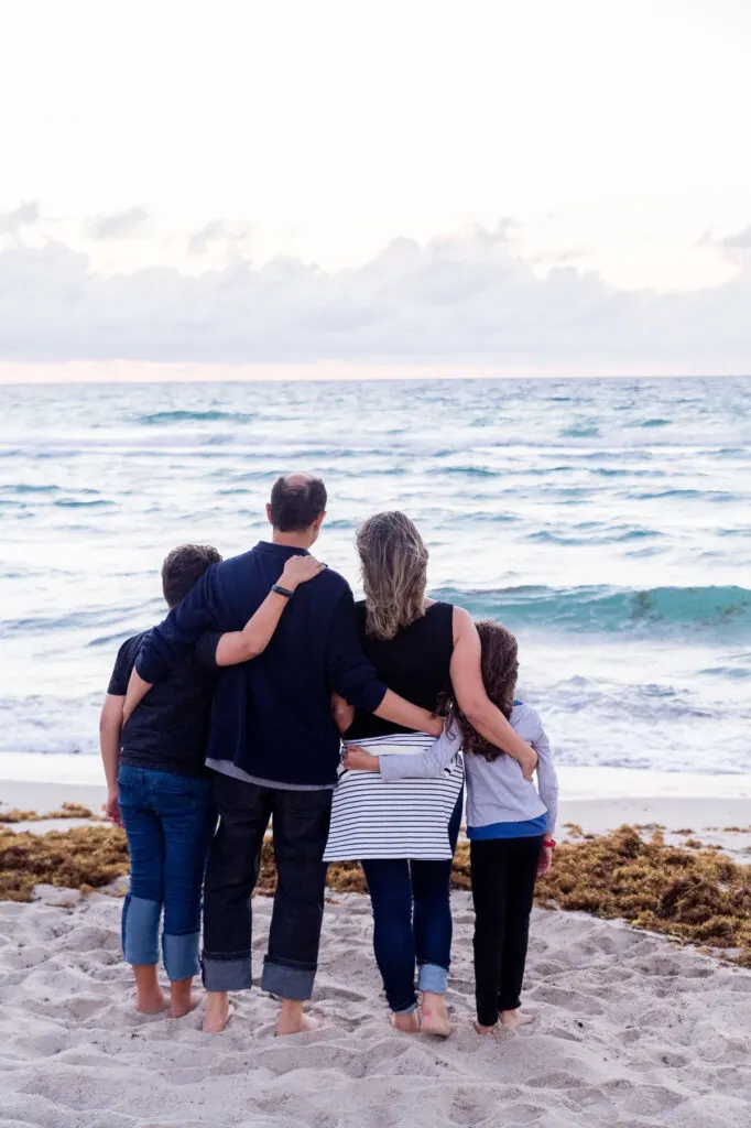a family standing in the beach