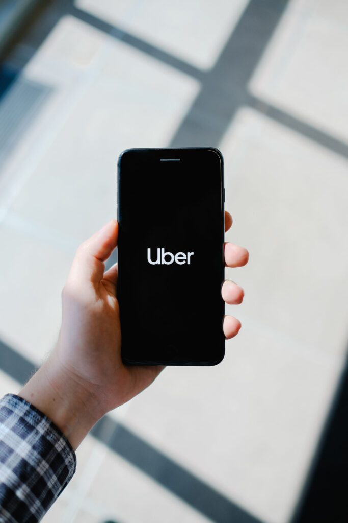 person holding a phone with an uber icon