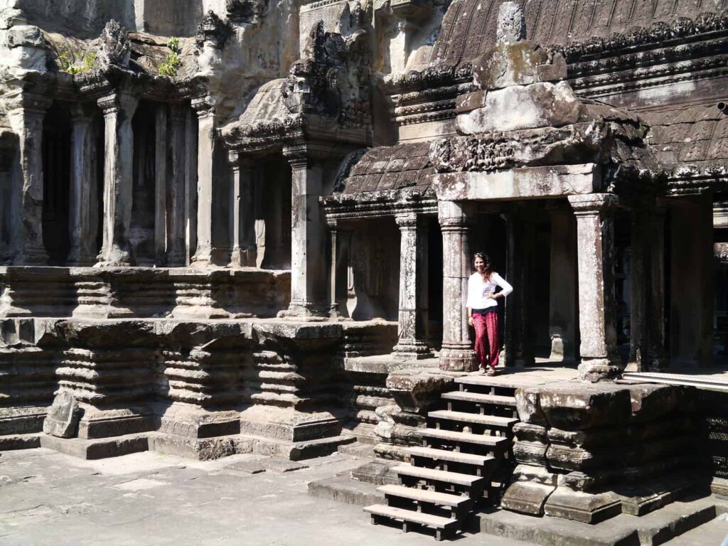 a woman standing in a temple in Angkor