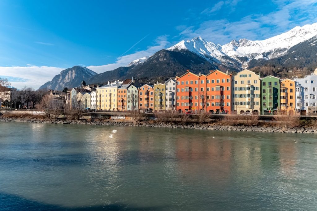a river running through a city with mountains in the background